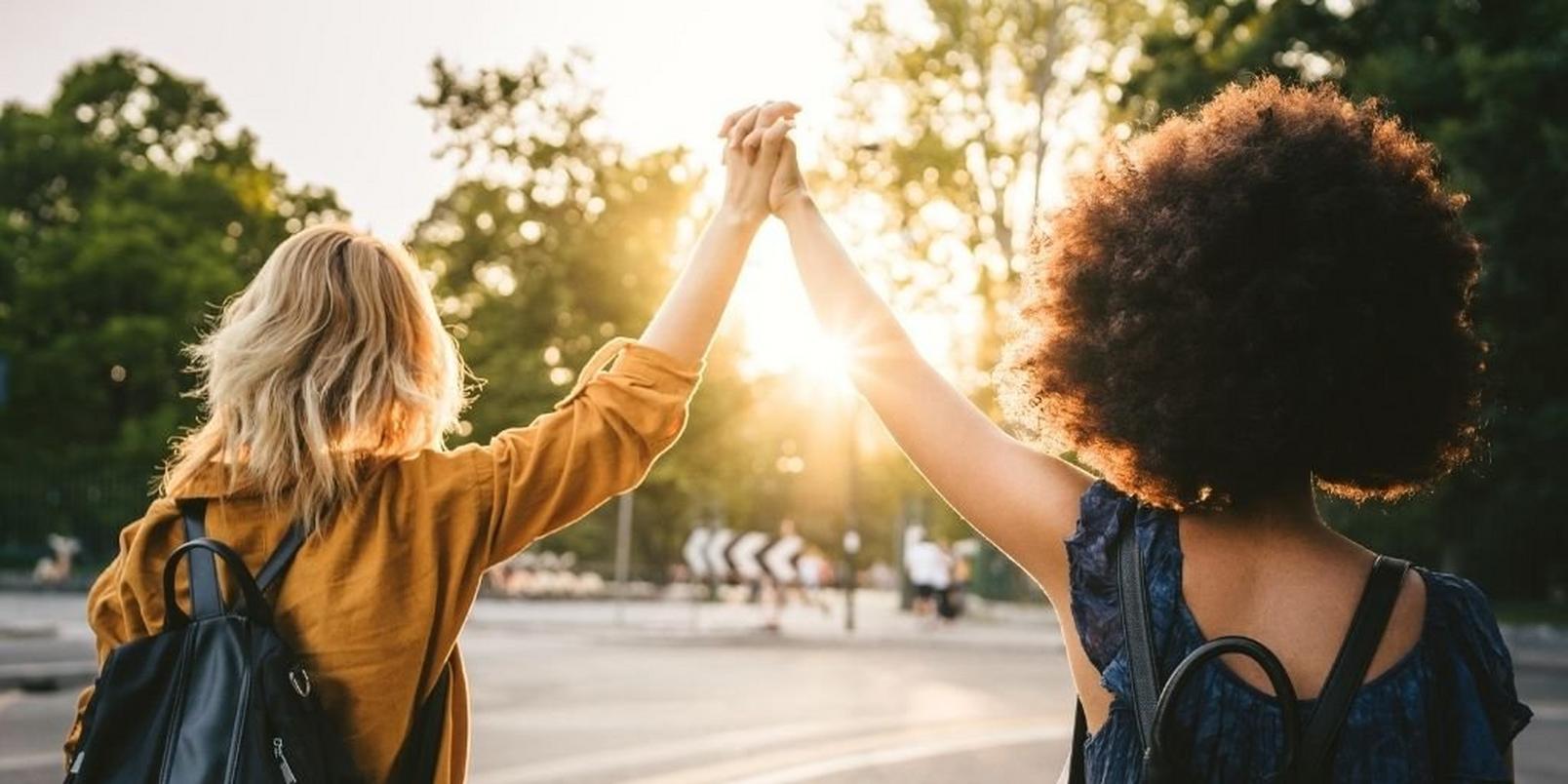 friends-holding-hands-walking