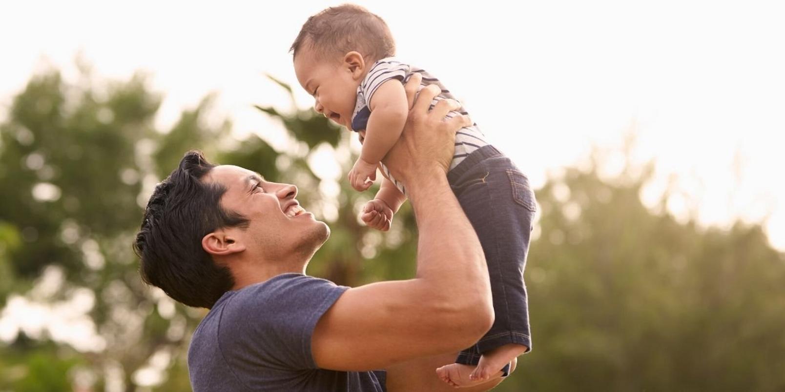 new-dad-with-baby-outdoors-playing