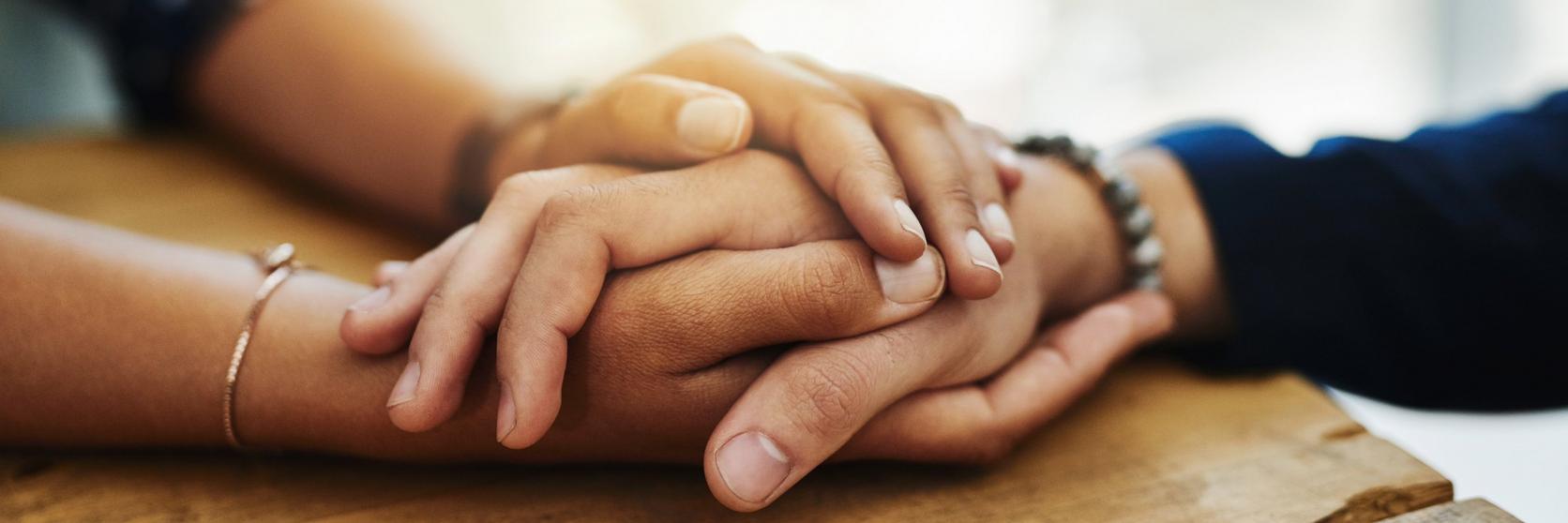 people-embracing-each-others-hands-sympathy
