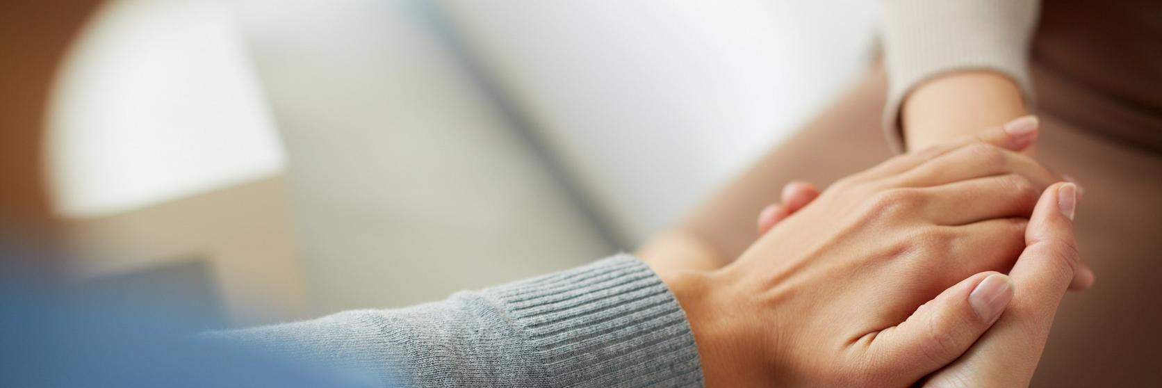 people-sympathetically-holding-hand